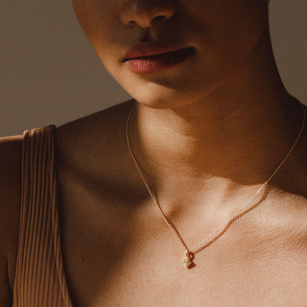 Wanderlust Life Castillo gold chain pyramid necklace. Tiny rays etched into the surface lend an extra dimension. An easy piece for layering with other necklaces. Proudly designed in Devon & handcrafted by our Wanderlust Life global artisan partners.