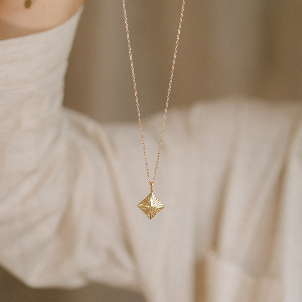 The Maya pendant is designed to capture and reflect any available light. Rays etched into the surface lend an extra dimension. An easy piece for layering with other necklaces. Proudly designed in Devon & handcrafted by our Wanderlust Life global artisan partners.