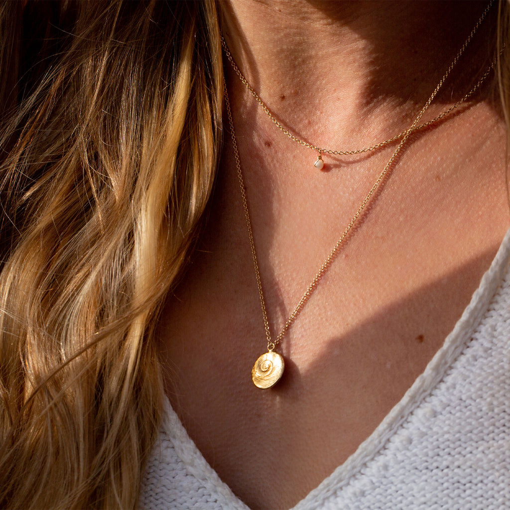 Wanderlust Life infinity shell 20 inch gold chain necklace. Proudly designed in Devon & handcrafted by our Wanderlust Life global artisan partners.